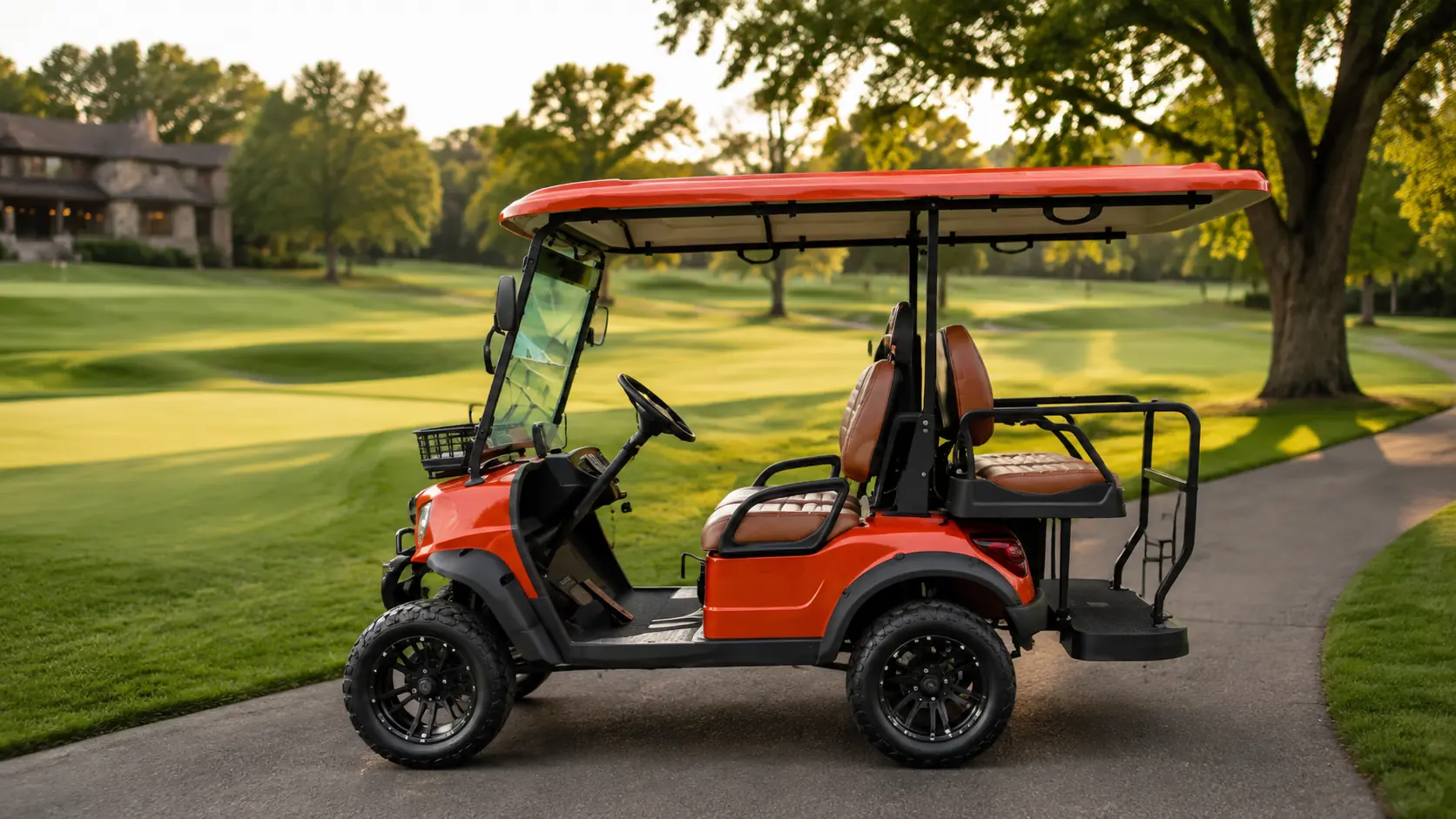 Orange Oreion 2–4 passenger electric golf cart on a luxury golf course