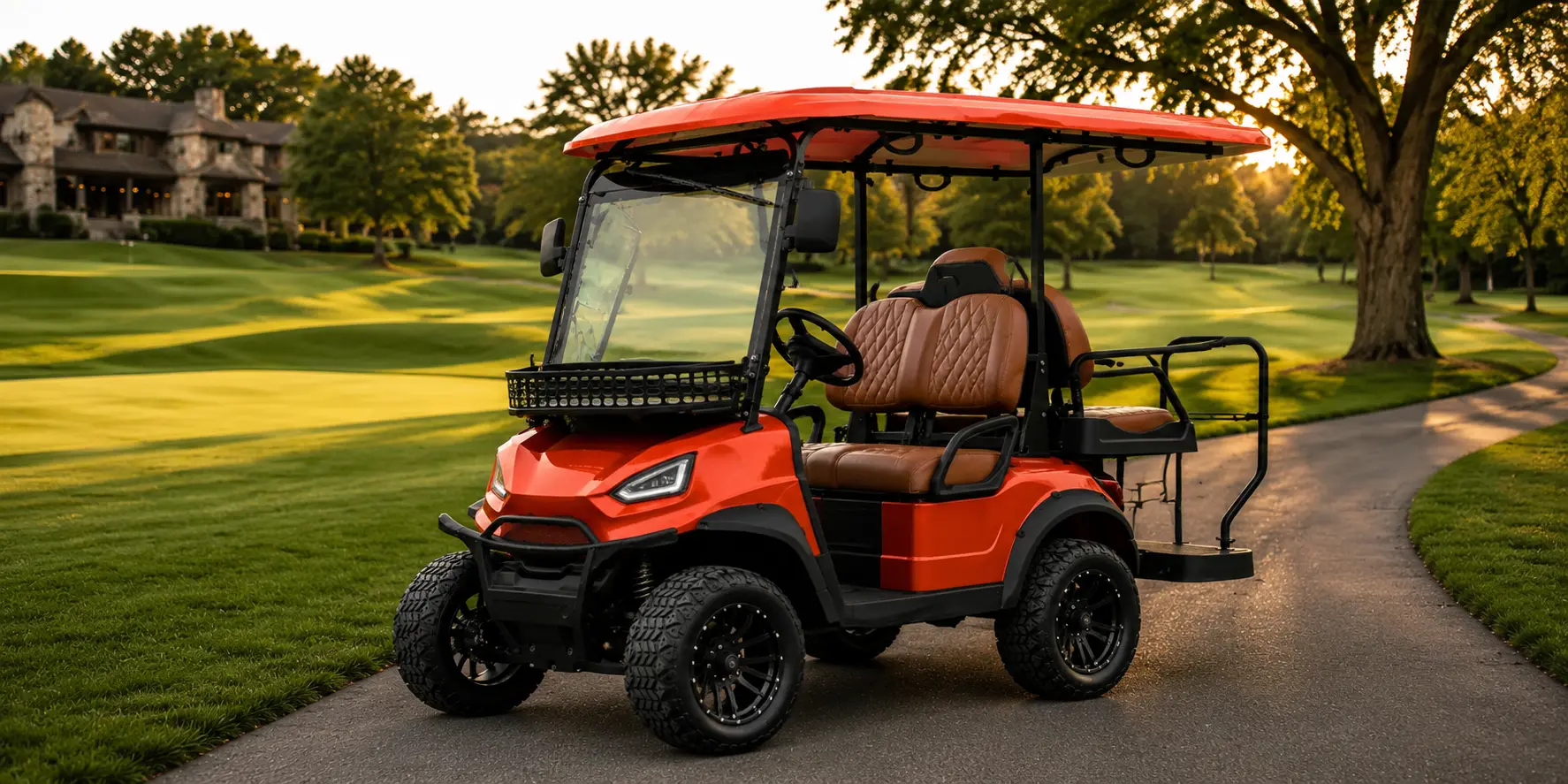Premium red Oreion 2 to 4 passenger electric golf cart on a luxury golf course