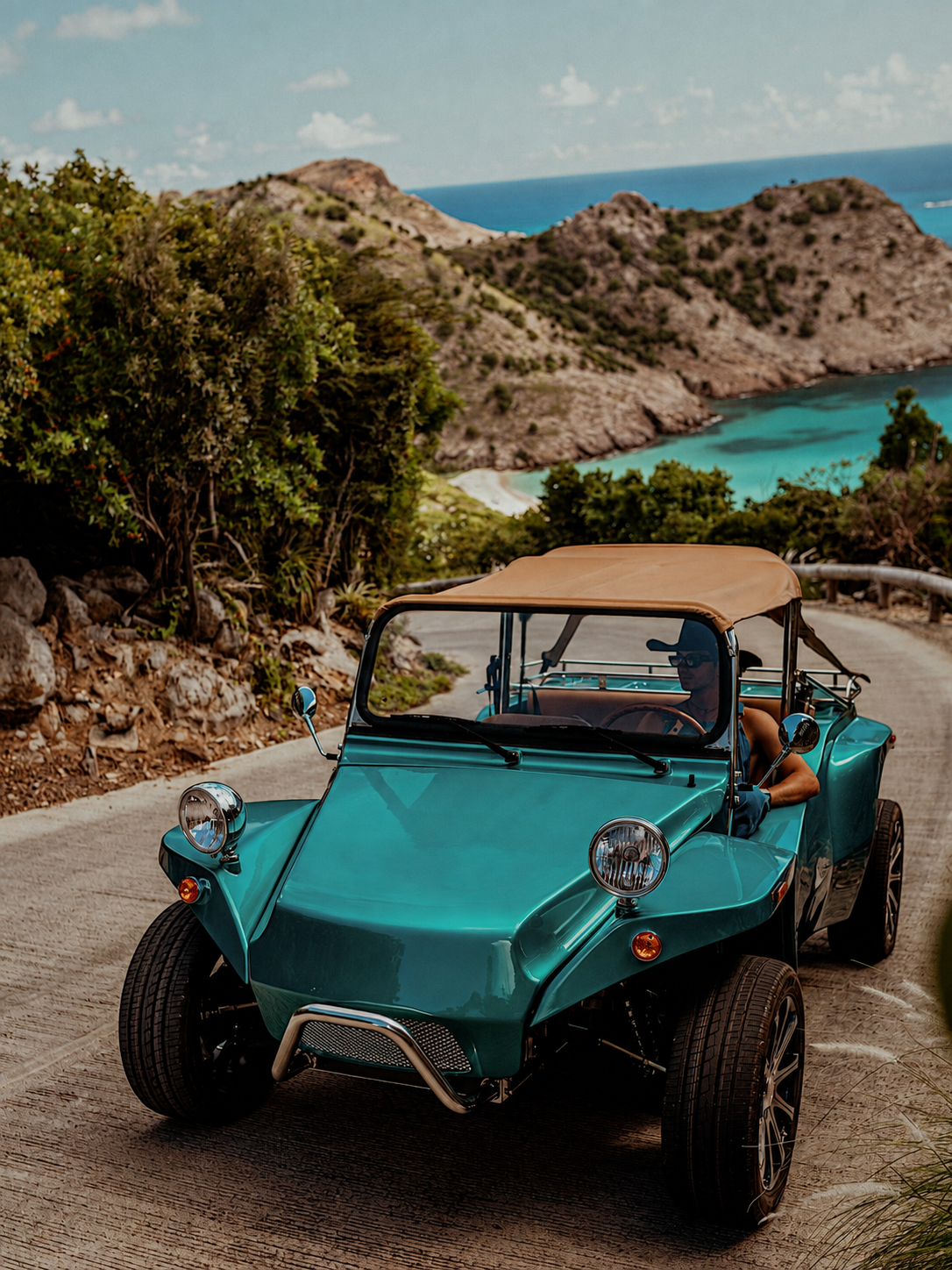 Turquoise Oreion Beach Buggy on a winding coastal road