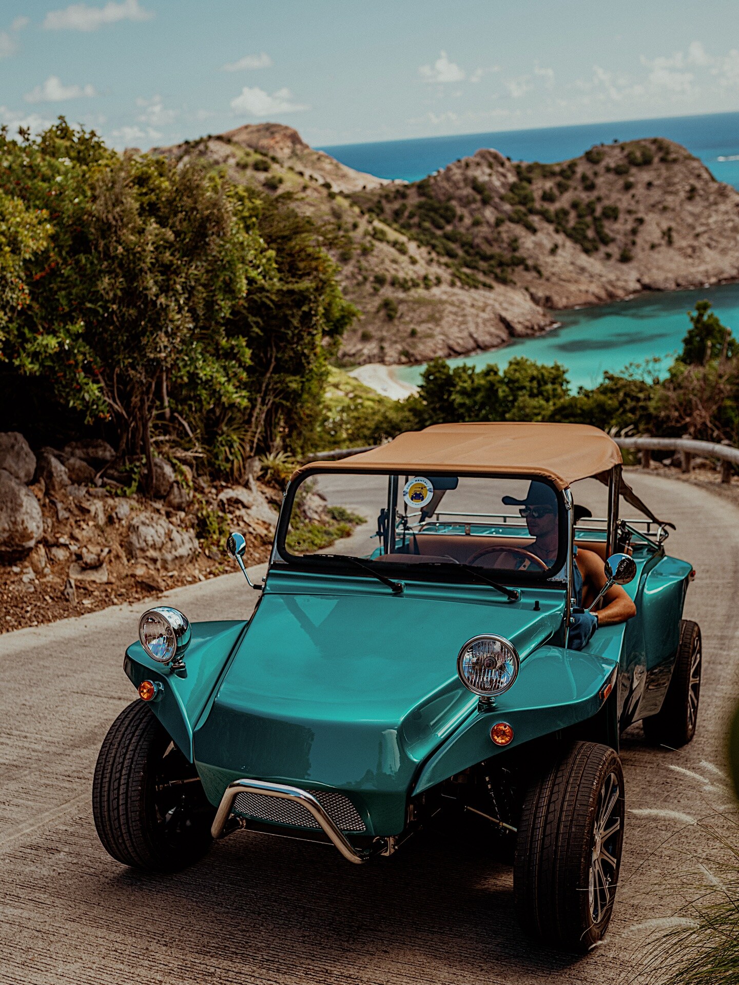 Turquoise Oreion Beach Buggy on a winding coastal road
