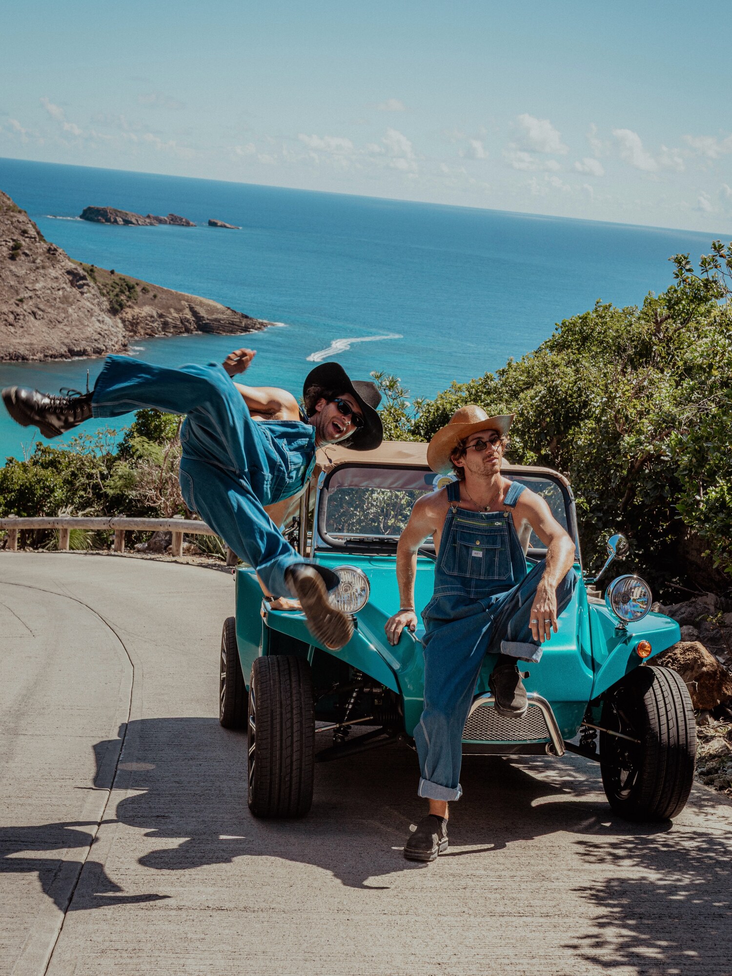 Turquoise Oreion Beach Buggy with two drivers overlooking the coast