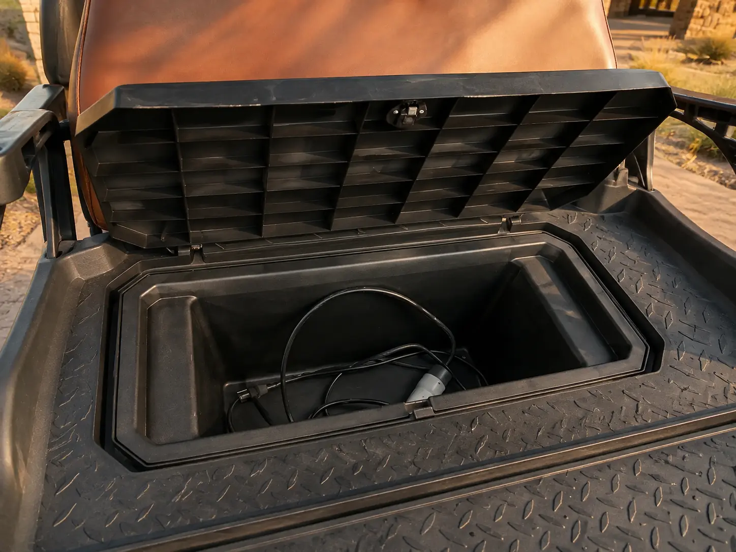 Open under-seat storage compartment in an Oreion electric golf cart