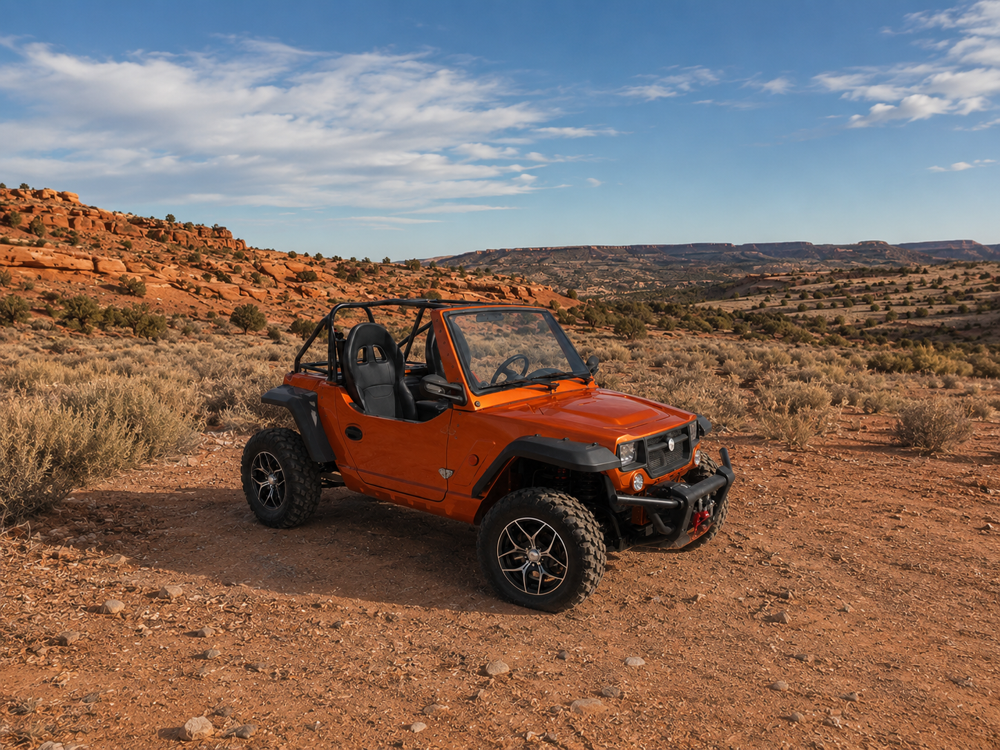 Orange Oreion Reeper Apex 1100cc two-seat off-road UTV on a red-rock trail