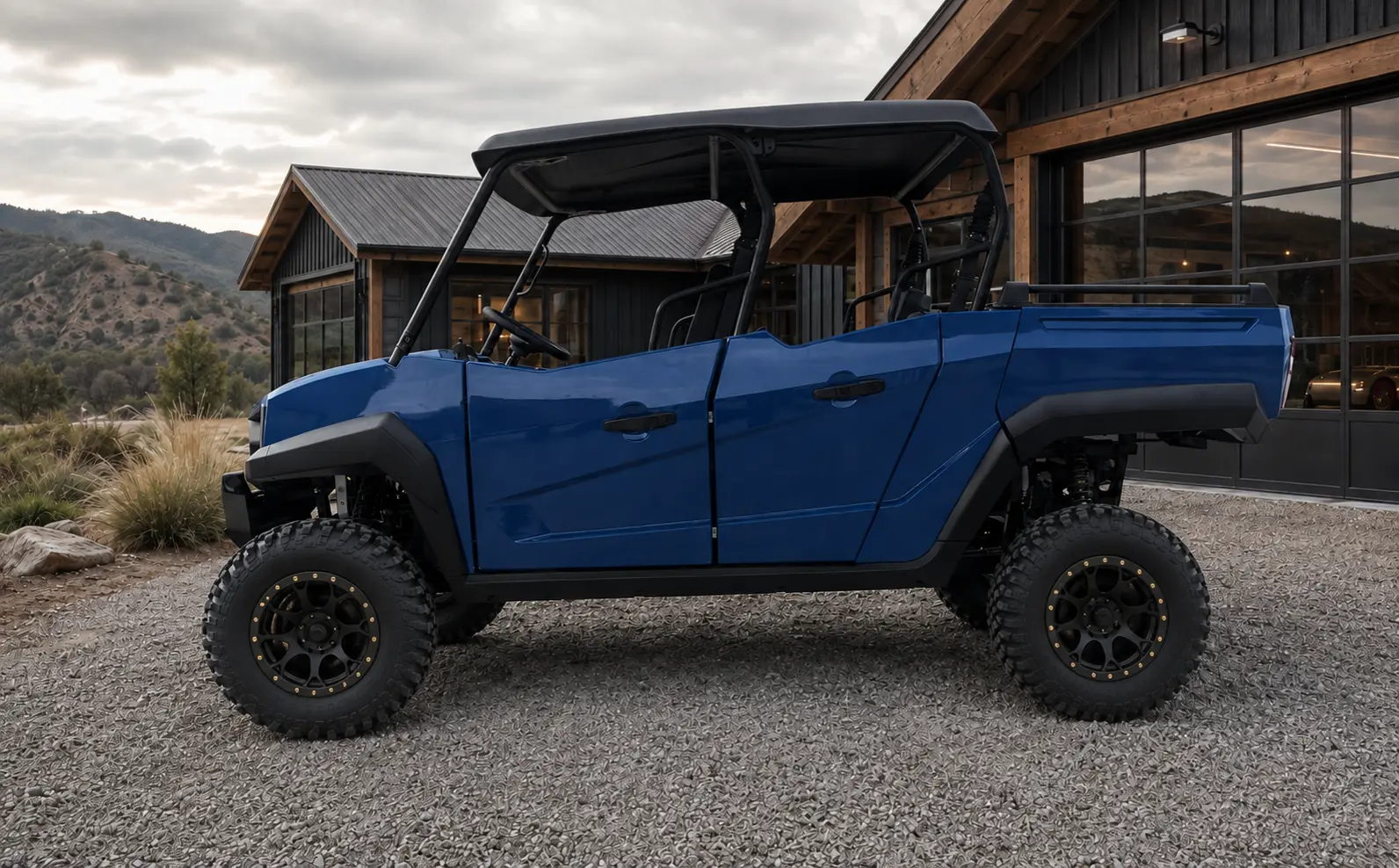 Blue Oreion Trailwarden 1000 four-door utility UTV in side profile beside a premium mountain workshop